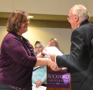 Lisa Coen receiving her member certificate from Sigma Beta Delta founding member Dr. Don Driemeier.