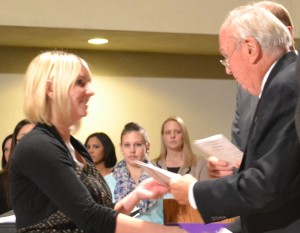 Jessica McCarren receives her member certificate from Sigma Beta Delta founding member Dr. Don Diremeier.